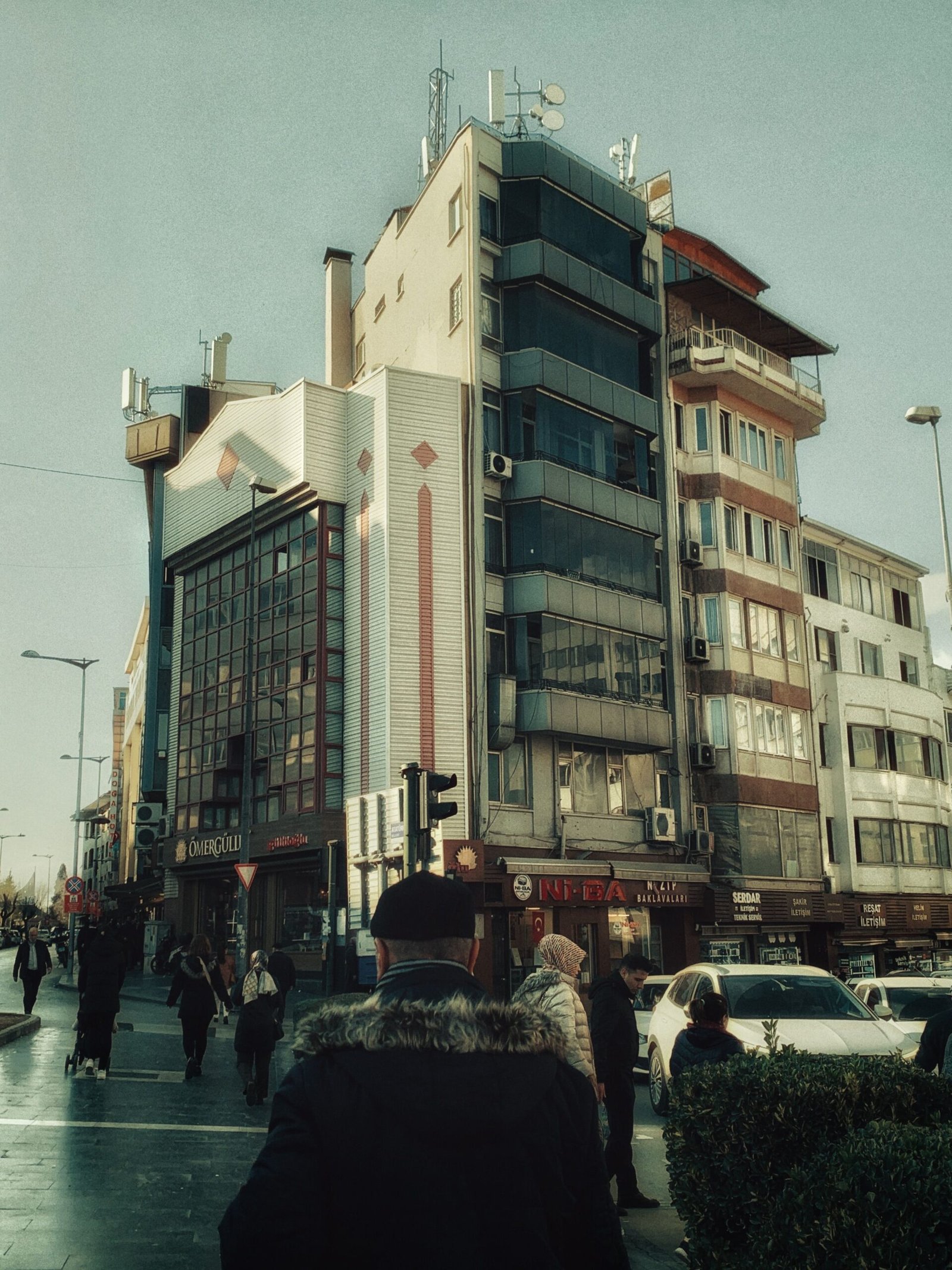 Street scene featuring modern architecture and pedestrians in daylight.